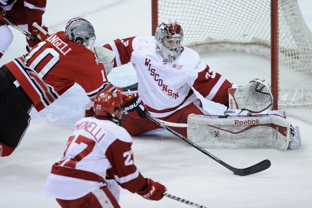 ST PAUL, MN - MARCH 22: Joel Rumpel #33 of the Wisconsin Badgers blocks a shot by Darik Angeli #10 of the Ohio State Buckeyes during the third period of the Big Ten Men's Ice Hockey Championship game on March 22, 2014 at Xcel Energy Center in St Paul, Minnesota. The Wisconsin Badgers defeated the Ohio State Buckeyes 5-4 in overtime. (Photo by Hannah Foslien/Getty Images)