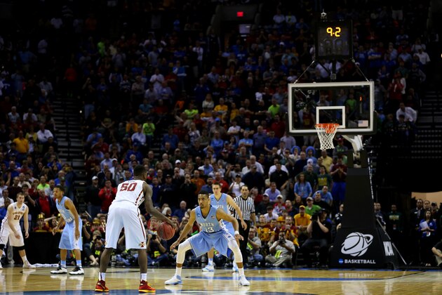 SAN ANTONIO, TX - MARCH 23: DeAndre Kane #50 of the Iowa State Cyclones brings the ball up the floor in the closing seconds as J.P. Tokoto #13 of the North Carolina Tar Heels defends during the third round of the 2014 NCAA Men's Basketball Tournament at the AT&T Center on March 23, 2014 in San Antonio, Texas.  (Photo by Ronald Martinez/Getty Images)