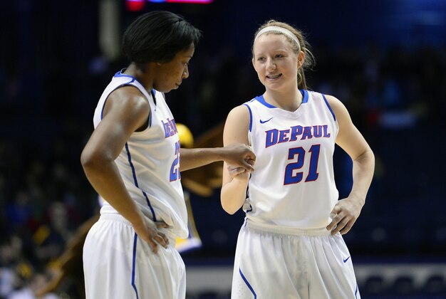 Mar 10, 2014; Rosemont, IL, USA; DePaul Blue Demons guard Megan Rogowski (21) reacts with forward Jasmine Penny (31) during the second half at Allstate Arena. DePaul defeats Marquette 100-90. Mandatory Credit: Mike DiNovo-USA TODAY Sports