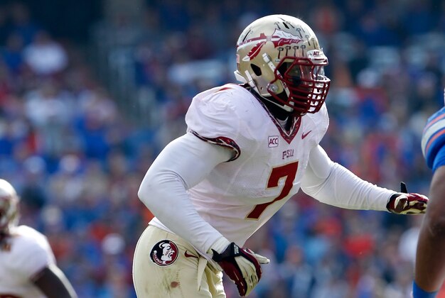 Nov 30, 2013; Gainesville, FL, USA; Florida State Seminoles linebacker Christian Jones (7) rushes against the Florida Gators during the second half at Ben Hill Griffin Stadium. Florida State Seminoles defeated the Florida Gators 37-7. Mandatory Credit: Kim Klement-USA TODAY Sports