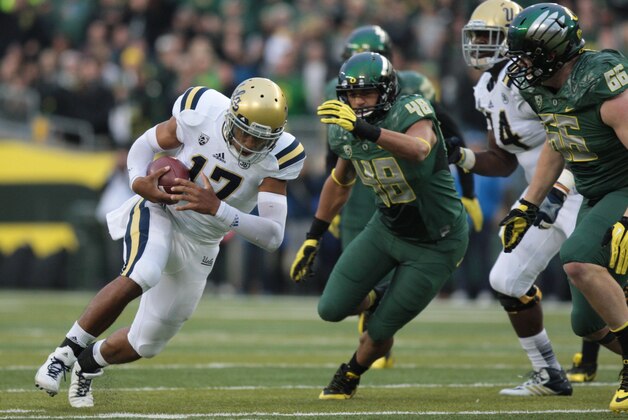 Oct 26, 2013; Eugene, OR, USA; UCLA Bruins quarterback Brett Hundley (17) runs the ball past Oregon Ducks linebacker Rodney Hardrick (48) at Autzen Stadium. Mandatory Credit: Scott Olmos-USA TODAY Sports