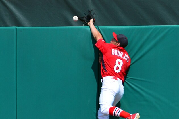 Mar 10, 2014; Jupiter, FL, USA; St. Louis Cardinals center fielder Peter Bourjos (8) makes an leaping attempt on a home run hit by Detroit Tigers third baseman Nick Castellanos (not pictured) at Roger Dean Stadium. The Tigers defeated the Cardinals 17-5. Mandatory Credit: Scott Rovak-USA TODAY Sports