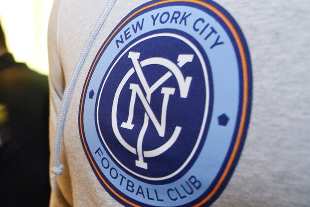 In this photo taken on March 20, 2014, and provided by New York City Football Club, sales people arrange team merchandise as they begin sales after the new MLS franchise New York City Football Club unveiled their new team badge  in New York. Over 100,000 fans voted over the internet to select the badge. The NYCFC will begin play in March of 2015. (AP Photo/New York City Football Club, Ray Stubblebine)