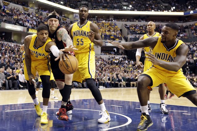 Miami Heat forward Chris Andersen, second from left, Indiana Pacers forward Paul George, left, center Roy Hibbert (55) and guard Lance Stephenson go for a loose rebound in the first half of an NBA basketball game in Indianapolis, Tuesday, Dec. 10, 2013. (AP Photo/Michael Conroy)