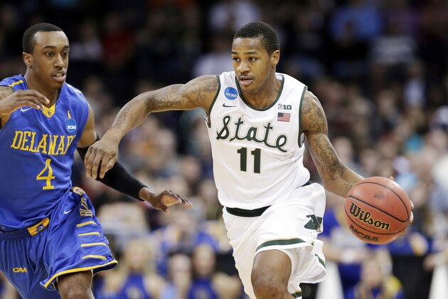 Michigan State's Keith Appling (11) drives in front of Delaware's Jarvis Threatt in the second half during the second round of the NCAA college basketball tournament in Spokane, Wash., Thursday, March 20, 2014. Michigan State won 93-78. (AP Photo/Elaine Thompson)