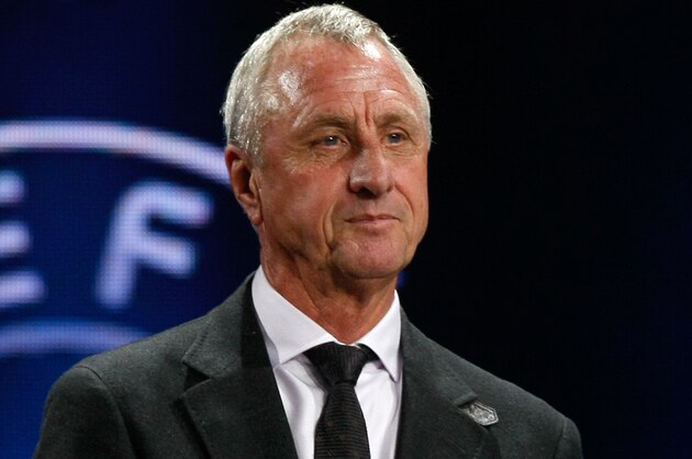 Former Netherlands player Johan Cruyff   shows the name of Atletico Madrid, who will play Group G,  during the UEFA Champions League draw in Monaco, Thursday, Aug. 29, 2013. (AP Photo/Claude Paris)