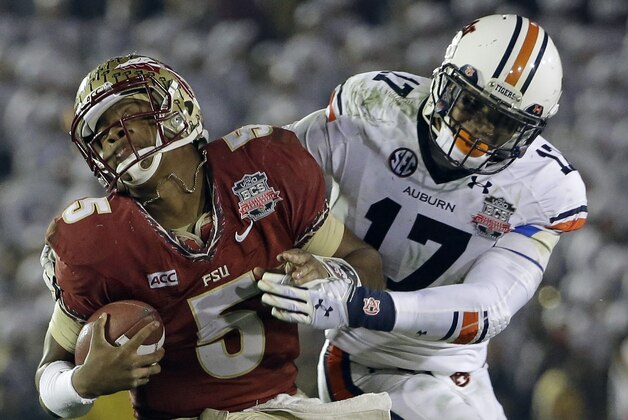 Auburn's Kris Frost tackles Florida State's Jameis Winston on a run during the second half of the NCAA BCS National Championship college football game Monday, Jan. 6, 2014, in Pasadena, Calif. (AP Photo/David J. Phillip)