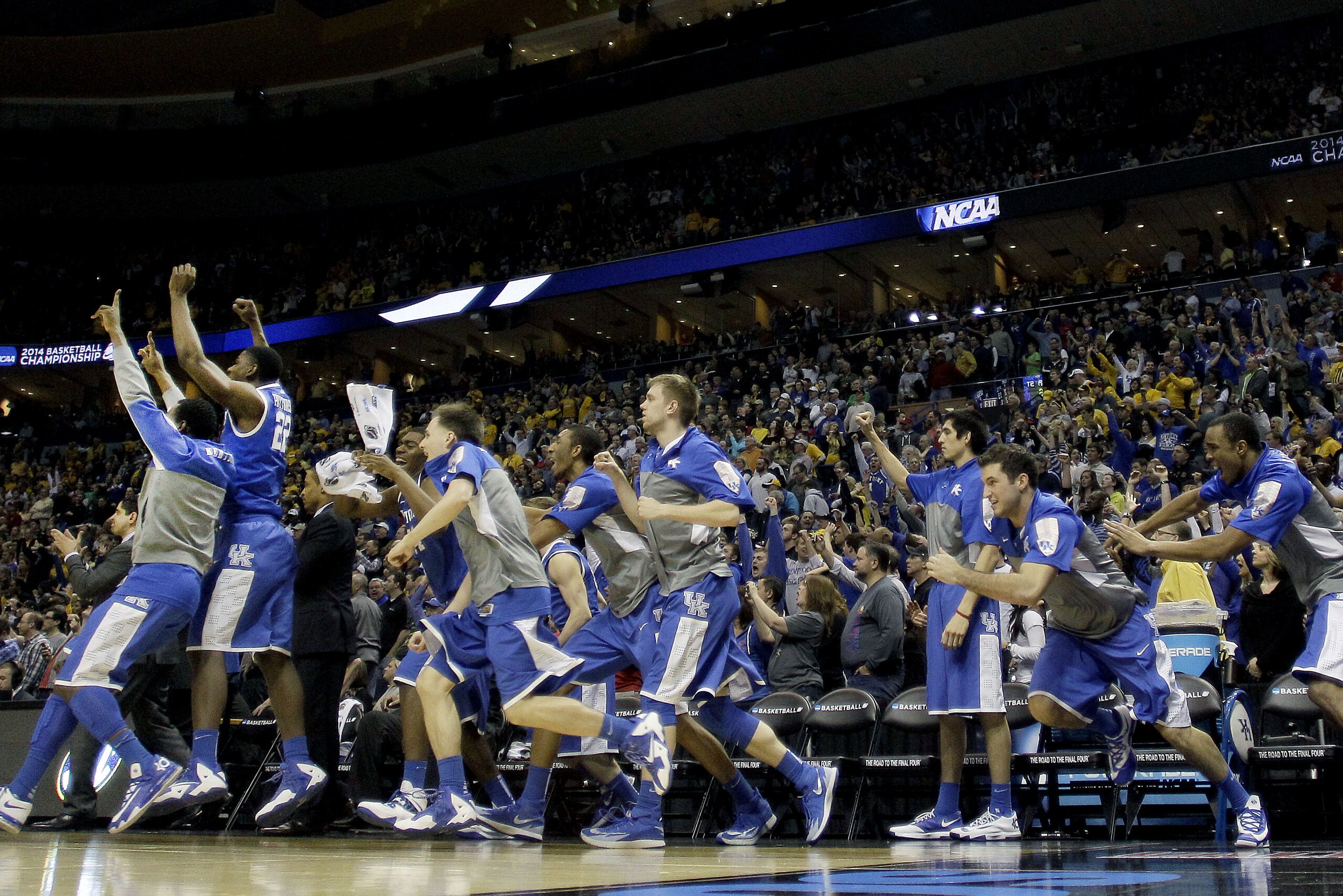 Kentucky players jump off the bench after winning a third-round game against Wichita State at the NCAA college basketball tournament Sunday, March 23, 2014, in St. Louis. Kentucky won the game 78-76. (AP Photo/Charlie Riedel)