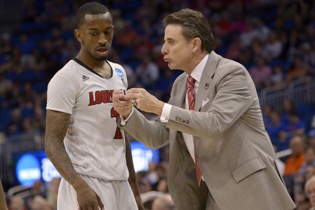 Louisville coach Rick Pitino yells at Louisville guard Russ Smith (2) during the second half in a third-round game in the NCAA college basketball tournament against Saint Louis,  Saturday, March 22, 2014, in Orlando, Fla. (AP Photo/Phelan M. Ebenhack)
