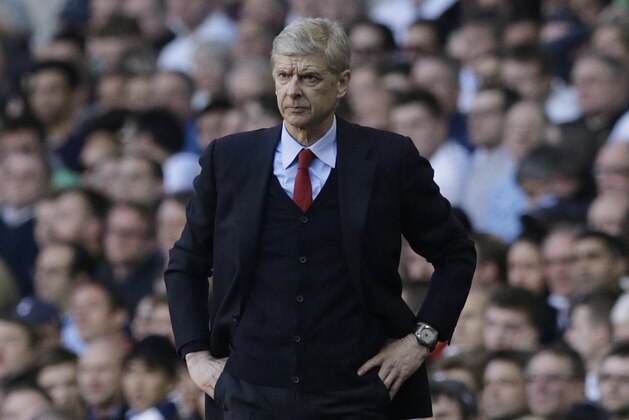 Arsenal's manager Arsene Wenger watches his team play from the technical area during the English Premier League soccer match between Tottenham Hotspur and Arsenal at White Hart Lane stadium in London, Sunday, March 16, 2014. (AP Photo/Matt Dunham)