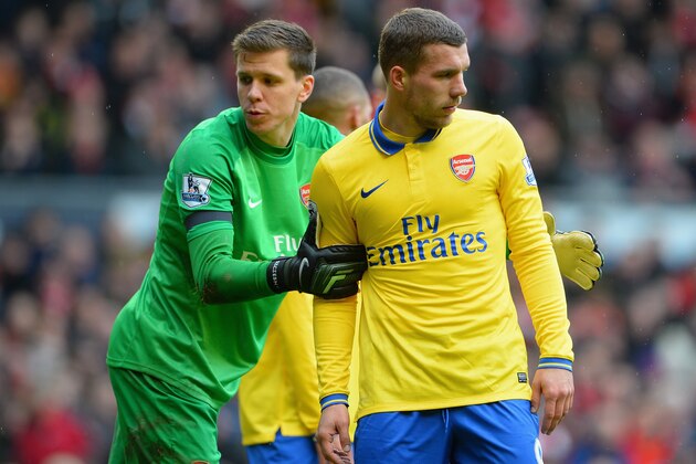 LIVERPOOL, ENGLAND - FEBRUARY 08:  Wojciech Szczesny grabs the arm of Lukas Podolski of Arsenal looks on during the Barclays Premier League match between Liverpool and Arsenal at Anfield on February 8, 2014 in Liverpool, England.  (Photo by Michael Regan/Getty Images)