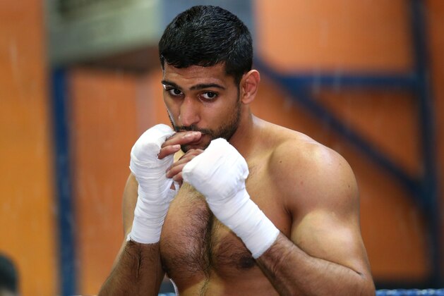 BOLTON, ENGLAND - MARCH 24:  Amir Khan shadow boxes during a media workout at the Gloves Community Centre on March 24, 2014 in Bolton, England.  (Photo by Alex Livesey/Getty Images)