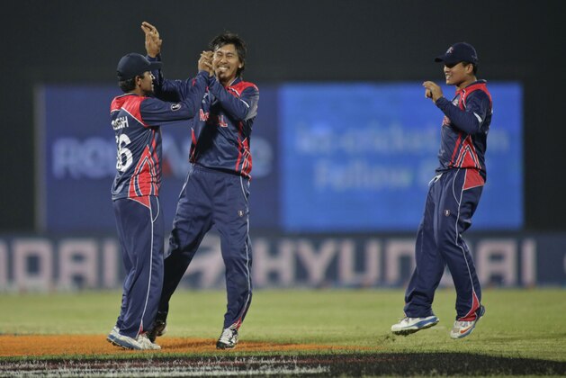 Nepal bowler Shakti Gauchan, center, celebrates the dismissal of Hong Kong's Aizaz Khan during their ICC Twenty20 Cricket World Cup match  in Chittagong, Bangladesh, Sunday, March 16, 2014. (AP Photo/Bikas Das)