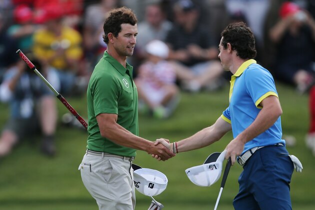 Rory McIlroy, right, of Northern Ireland shakes hands with Australia's Adam Scott following their third round at the Australian Open Golf tournament in Sydney, Australia, Saturday, Nov. 30, 2013.(AP Photo/Rob Griffith)