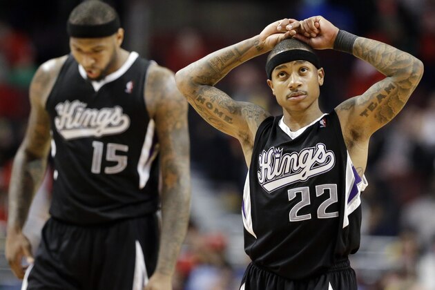 Sacramento Kings guard Isaiah Thomas, right, reacts after center DeMarcus Cousins (15) fouled Chicago Bulls guard Mike Dunleavy during the second half of an NBA basketball game in Chicago on Saturday, March 15, 2014. The Bulls won 94-87. (AP Photo/Nam Y. Huh)