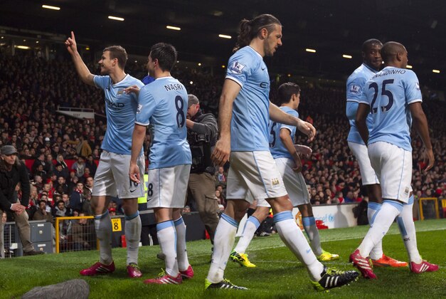 Manchester City's Edin Dzeko, left, celebrates after scoring his second goal against Manchester United during their English Premier League soccer match at Old Trafford Stadium, Manchester, England, Tuesday March 25, 2014. (AP Photo/Jon Super) Manchester City's Edin Dzeko, left, celebrates after scoring his second goal against Manchester United during their English Premier League soccer match at Old Trafford Stadium, Manchester, England, Tuesday March 25, 2014. (AP Photo/Jon Super)