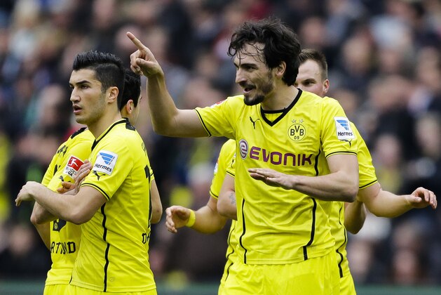 Dortmund's Mats Hummels, right, celebrates after he scored his side's first goal during the German first division Bundesliga soccer match between Hannover 96 and  BvB Borussia Dortmund in Hannover, Germany, Saturday, March 22, 2014. (AP Photo/Markus Schreiber).