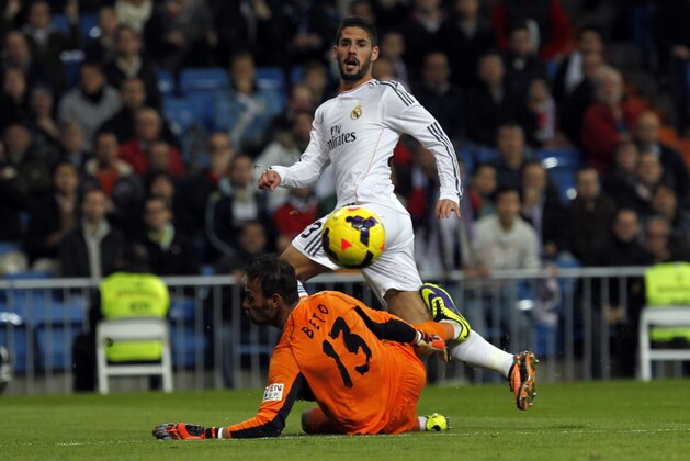 Real Madrid's Francisco Alarcon Isco, top, challenges Sevilla's goalkeeper Beto, from Portugal, during a Spanish La Liga soccer match between Real Madrid and Sevilla at the Santiago Bernabeu stadium in Madrid, Spain, Wednesday Oct. 30, 2013. Real Madrid won 7-3. (AP Photo/Francisco Seco)
