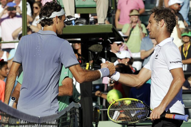 Roger Federer, left, of Switzerland, shakes hands with Richard Gasquet, of France, right, after he defeated Gasquet 6-1, 6-2 during the Sony Open tennis tournament Tuesday, March 25, 2014, in Key Biscayne, Fla. (AP Photo/Luis M. Alvarez)