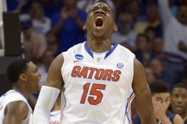 Florida forward Will Yeguete (15) yells after scoring against Pittsburgh during the second half in a third-round game in the NCAA college basketball tournament  Saturday, March 22, 2014, in Orlando, Fla. (AP Photo/Phelan M. Ebenhack)
