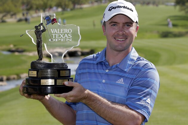 Martin Laird, of Scotland, poses with his trophy after winning  the Texas Open golf tournament, Sunday, April 7, 2013, in San Antonio.  (AP Photo/Eric Gay)