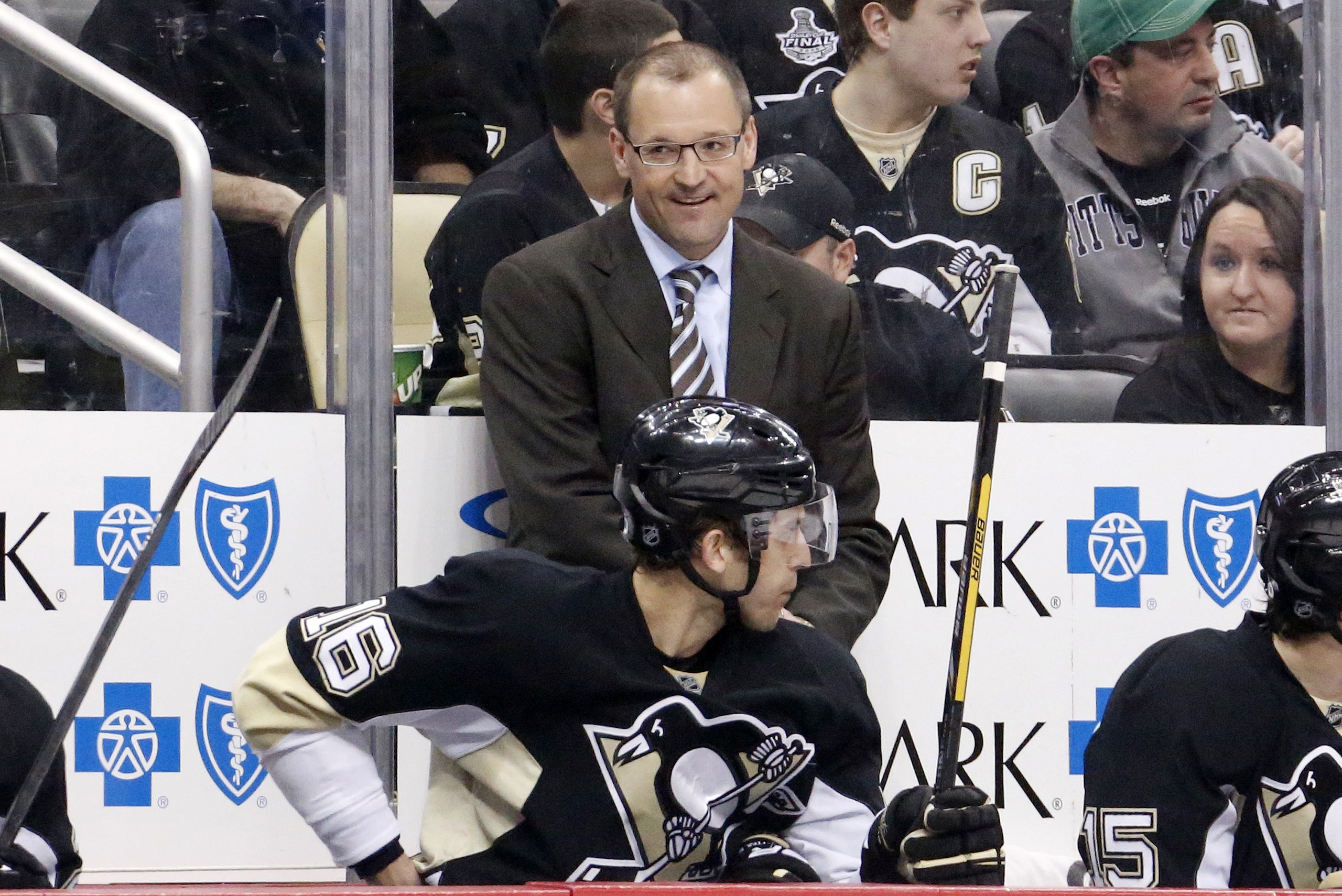 Pittsburgh Penguins head coach Dan Bylsma stands behind his bench during an NHL hockey game between the Pittsburgh Penguins and the Tampa Bay Lightning in Pittsburgh, Saturday, March 22, 2014. (AP Photo/Gene J. Puskar)