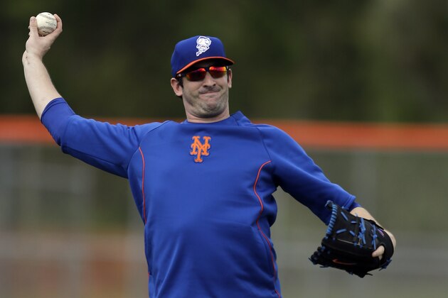 FILE - In this Feb. 22, 2014 file photo, New York Mets pitcher Matt Harvey plays catch during spring training baseball practice in Port St. Lucie, Fla. The Mets and Harvey have agreed where the pitcher will rehabilitate from elbow ligament-replacement surgery. General manager Sandy Alderson said Tuesday, March 25, 2014,  the right-hander will be with the club in New York during homestands and work at the team's spring training complex in Port St. Lucie when the Mets are on the road. (AP Photo/Jeff Roberson, File)