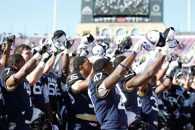 FORT WORTH, TX - DECEMBER 30:  Players of the Navy Midshipmen celebrate after a game against the Middle Tennessee Blue Raiders during the Bell Helicopter Armed Forces Bowl at Amon G. Carter Stadium on December 30, 2013 in Fort Worth, Texas. The Navy Midshipmen defeated the Middle Tennessee Blue Raiders 24-6.  (Photo by Sarah Glenn/Getty Images)