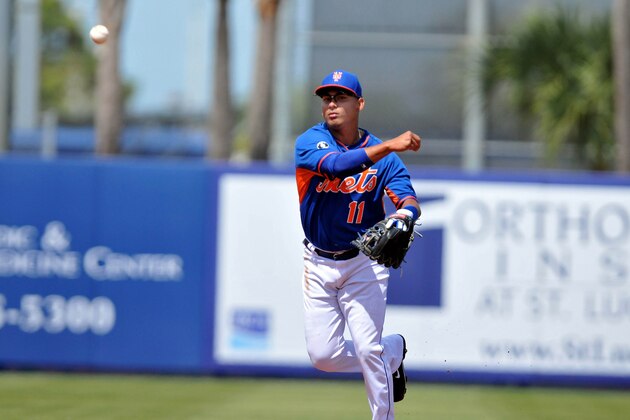 Mar 9, 2014; Port St. Lucie, FL, USA; New York Mets shortstop Ruben Tejada (11) throws to first against the Atlanta Braves in spring training action at Tradition Stadium. Mandatory Credit: Brad Barr-USA TODAY Sports