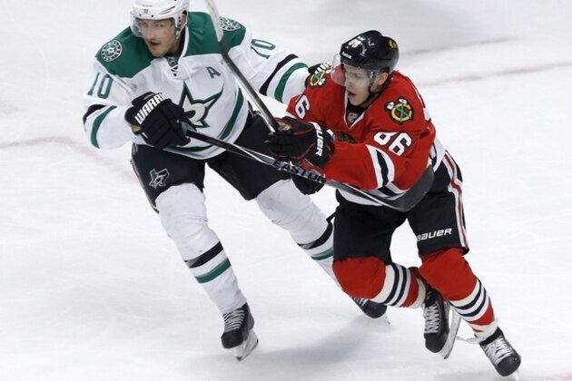 Chicago Blackhawks rookie Teuvo Teravainen (86) from Finland, skates again Dallas Stars center Shawn Horcoff (10) during the first period of an NHL hockey game Tuesday, March 25, 2014, in Chicago. (AP Photo/Charles Rex Arbogast)