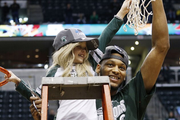 Mar 16, 2014; Indianapolis, IN, USA; Michigan State Spartans center Adreian Payne (5) hold up the net with 8 year old cancer patient Lacey Hollsworth after defeating the Michigan Wolverines in the championship game for the Big Ten college basketball tournament at Bankers Life Fieldhouse. Michigan State defeats Michigan 69-55. Mandatory Credit: Brian Spurlock-USA TODAY Sports Mar 16, 2014; Indianapolis, IN, USA; Michigan State Spartans center Adreian Payne (5) hold up the net with 8 year old cancer patient Lacey Hollsworth after defeating the Michigan Wolverines in the championship game for the Big Ten college basketball tournament at Bankers Life Fieldhouse. Michigan State defeats Michigan 69-55. Mandatory Credit: Brian Spurlock-USA TODAY Sports