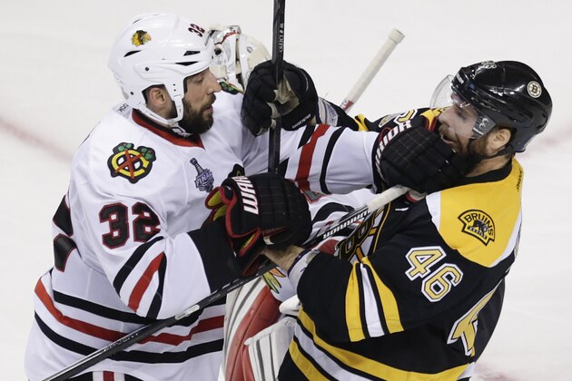 Chicago Blackhawks defenseman Michal Rozsival (32), of the Czech Republic, and Boston Bruins center David Krejci (46), of the Czech Republic, tangle during the third period in Game 6 of the NHL hockey Stanley Cup Finals, Monday, June 24, 2013, in Boston. (AP Photo/Charles Krupa)
