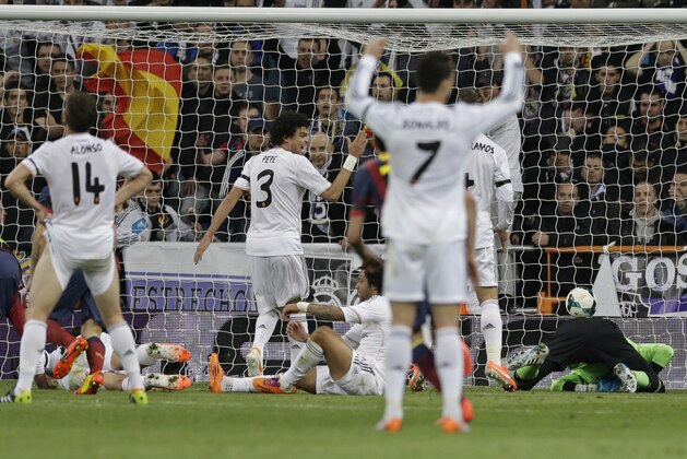 Real Madrid players react as Real Madrid's goalkeeper Diego Lopez, right concedes a goal by FC Barcelona's Lionel Messi from Argentina during a Spanish La Liga soccer match at the Santiago Bernabeu stadium in Madrid, Sunday March 23, 2014. (AP Photo/Paul White)