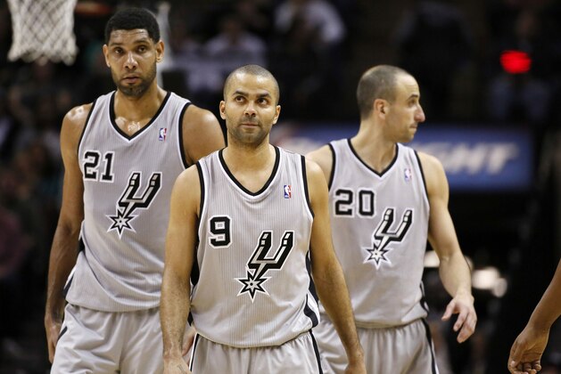 Jan 17, 2014; San Antonio, TX, USA; San Antonio Spurs players Tim Duncan (21) and Tony Parker (9) and Manu Ginobili (20) react during the second half against the Portland Trail Blazers at AT&T Center. The Blazers won 109-100. Mandatory Credit: Soobum Im-USA TODAY Sports