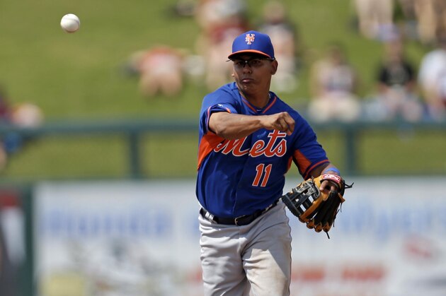 New York Mets shortstop Ruben Tejada (11) throws out Minnesota Twins center fielder Alex Presley on a ground out during the fifth inning of an exhibition baseball game in Fort Myers, Fla., Friday, March 21, 2014. (AP Photo/Gerald Herbert)