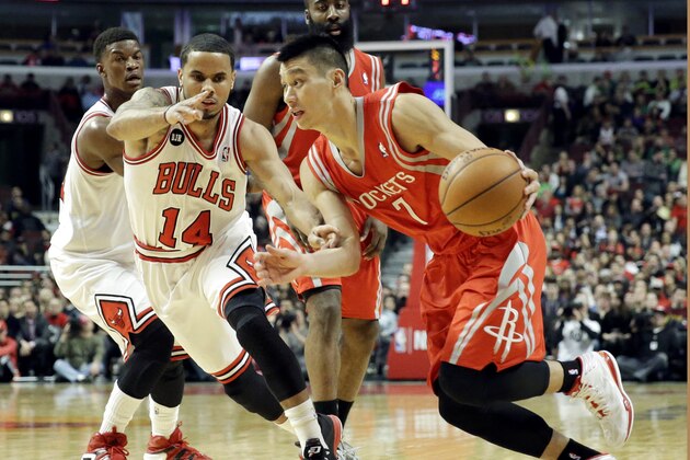 Houston Rockets guard Jeremy Lin (7) drives to the basket as Chicago Bulls guard D.J. Augustin (14) guards during the first half of an NBA basketball game in Chicago on Thursday, March 13, 2014. (AP Photo/Nam Y. Huh)