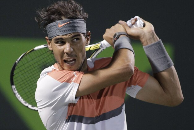 Rafael Nadal, of Spain, follows through on a return to Fabio Fognini, of Italy, during the Sony Open tennis tournament, Tuesday, March 25, 2014, in Key Biscayne, Fla. Nadal won 6-2, 6-2. (AP Photo/Luis M. Alvarez)