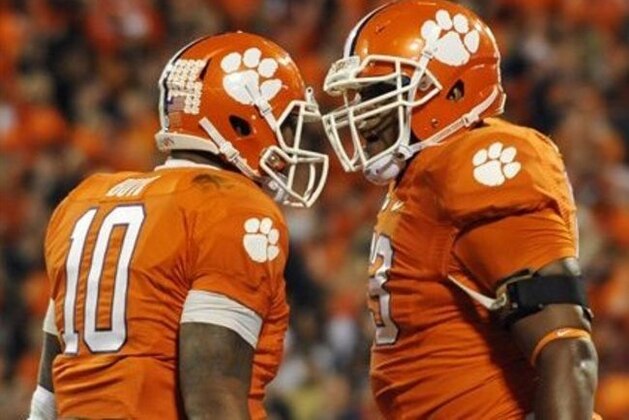 Clemson's Tajh Boyd (10) celebrates with teammate Brandon Thomas, right, after scoring a touchdown against South Carolina during the first half of an NCAA college football game on Saturday, Nov. 24, 2012, in Clemson, S.C. (AP Photo/Rainier Ehrhardt)
