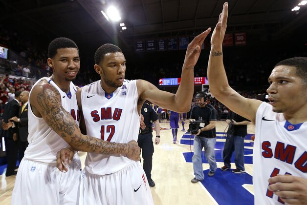 SMU guards Keith Frazier (4), Nick Russell (12) and guard Nic Moore (11) celebrate after winning an NCAA college basketball game against LSU in the second round of the NIT Monday, March 24, 2014, in Dallas, Texas. (AP Photo/Sharon Ellman)