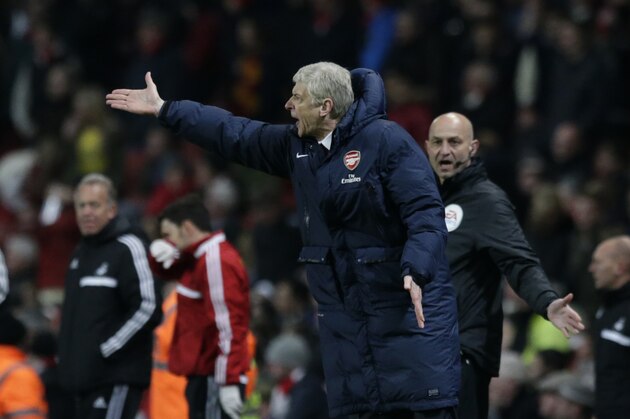 Arsenal's French manager Arsene Wenger shouts after Swansea City equalized through a Mathieu Flamini own goal to make the final score 2-2 during the English Premier League soccer match between Arsenal and Swansea City at the Emirates Stadium in London, Tuesday, March 25, 2014. (AP Photo/Matt Dunham)