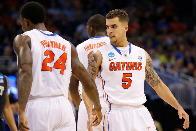 ORLANDO, FL - MARCH 22:  Scottie Wilbekin #5 of the Florida Gators reacts with Casey Prather #24 after making a three-pointer in the second half against the Pittsburgh Panthers in the second half during the third round of the 2014 NCAA Men's Basketball Tournament at Amway Center on March 22, 2014 in Orlando, Florida.  (Photo by Kevin C. Cox/Getty Images)