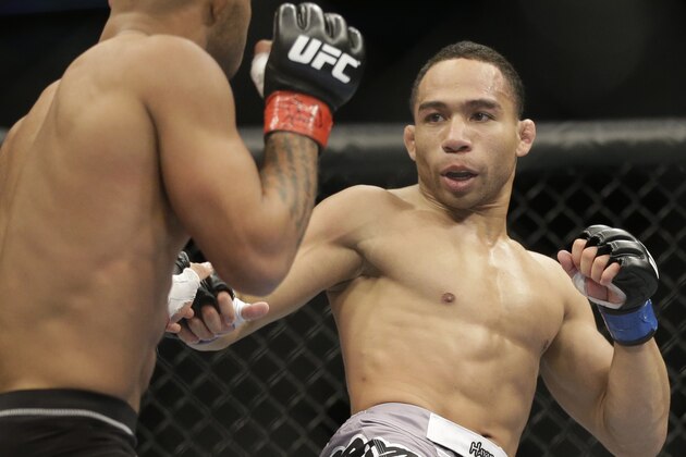 John Dodson, right, fights Demetrious Johnson during UFC World Flyweight Championship on FOX 6 at the United Center in Chicago, Saturday, Jan. 26, 2013. Johnson won the bout. (AP Photo/Nam Y. Huh)