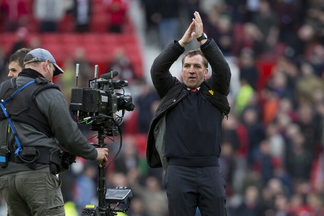 Liverpool's manager Brendan Rodgers applauds supporters after his team's 3-0 win against Manchester United in their English Premier League soccer match at Old Trafford Stadium, Manchester, England, Sunday March 16, 2014. (AP Photo/Jon Super)