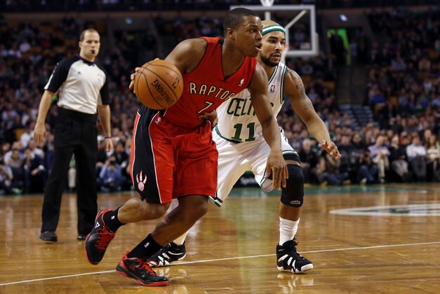 Jan 15, 2014; Boston, MA, USA;  Toronto Raptors point guard Kyle Lowry (7) drives to the basket while guarded by Boston Celtics guard Jerryd Bayless (11) during the first quarter at TD Garden. Mandatory Credit: Greg M. Cooper-USA TODAY Sports