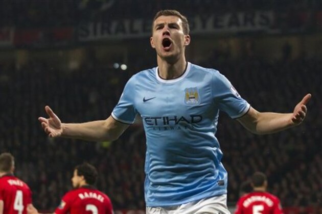 Manchester City's Edin Dzeko celebrates after scoring his second goal against Manchester United during their English Premier League soccer match at Old Trafford Stadium, Manchester, England, Tuesday March 25, 2014. (AP Photo/Jon Super)