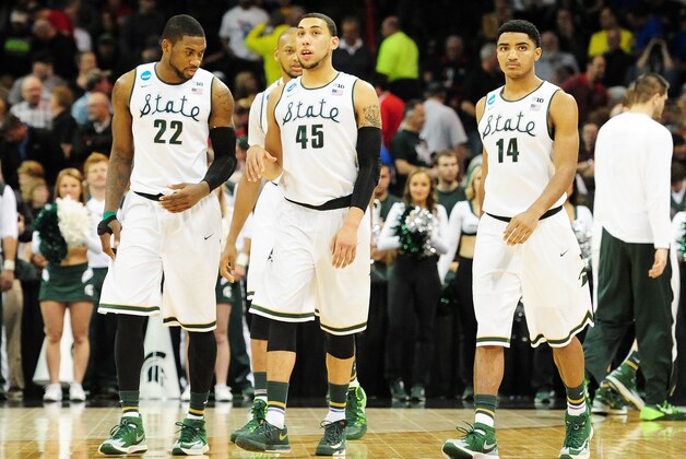 SPOKANE, WA - MARCH 22:  Branden Dawson #22 Adreian Payne #5 Denzel Valentine #45 and Gary Harris #14 of the Michigan State Spartans look on in the second half against the Harvard Crimson during the Third Round of the 2014 NCAA Basketball Tournament at Spokane Veterans Memorial Arena on March 22, 2014 in Spokane, Washington.  (Photo by Steve Dykes/Getty Images)