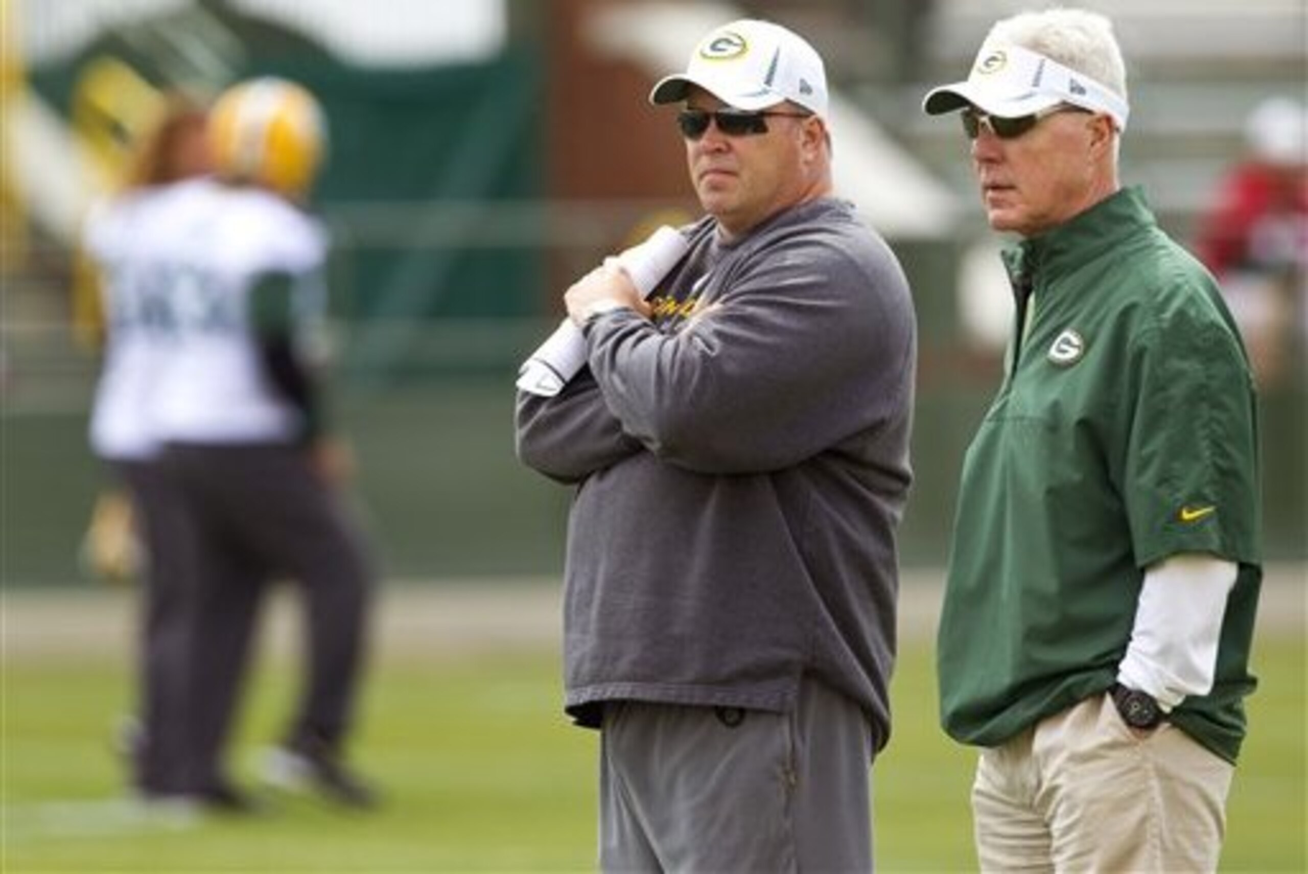 Green Bay Packers coach Mike McCarthy, left, and general manager Ted Thompson watch the NFL football team's minicamp Tuesday, June 12, 2012, in Green Bay, Wis.  (AP Photo/Mike Roemer)