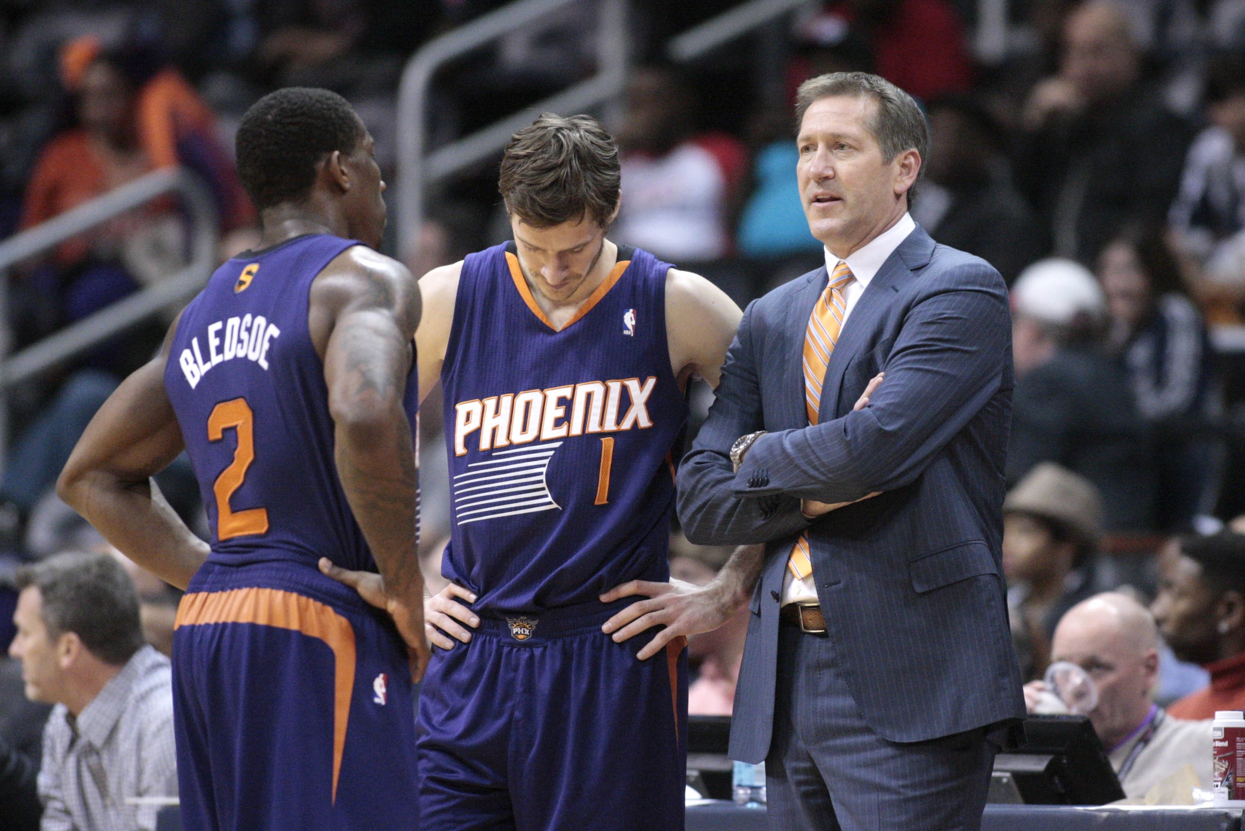 Phoenix Suns head coach Jeff Hornacek, right, talks with Phoenix Suns guard Eric Bledsoe (2) and Phoenix Suns guard Goran Dragic (1) during a break from an NBA basketball game against the Atlanta Hawks Monday, March 24, 2014, in Atlanta. Phoenix defeated Atlanta 102-95. (AP Photo/Jason Getz)