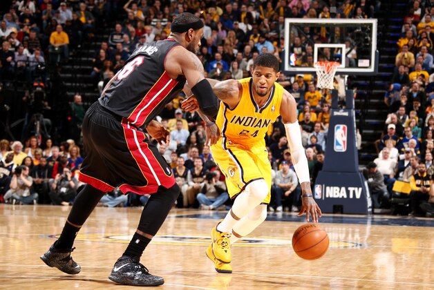 INDIANAPOLIS, IN - MARCH 26: Paul George #24 of the Indiana Pacers drives against LeBron James #6 of the Miami Heat during a game on March 26, 2014 at Bankers Life Fieldhouse in Indianapolis, IN.  NOTE TO USER: User expressly acknowledges and agrees that, by downloading and or using this photograph, User is consenting to the terms and conditions of the Getty Images License Agreement. Mandatory Copyright Notice: Copyright 2014 NBAE  (Photo by Nathaniel S. Butler/NBAE via Getty Images)