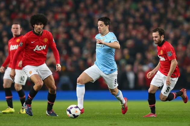 MANCHESTER, ENGLAND - MARCH 25:  Samir Nasri of Manchester City competes with Marouane Fellaini and Juan Mata (R) of Manchester United during the Barclays Premier League match between Manchester United and Manchester City at Old Trafford on March 25, 2014 in Manchester, England.  (Photo by Alex Livesey/Getty Images)